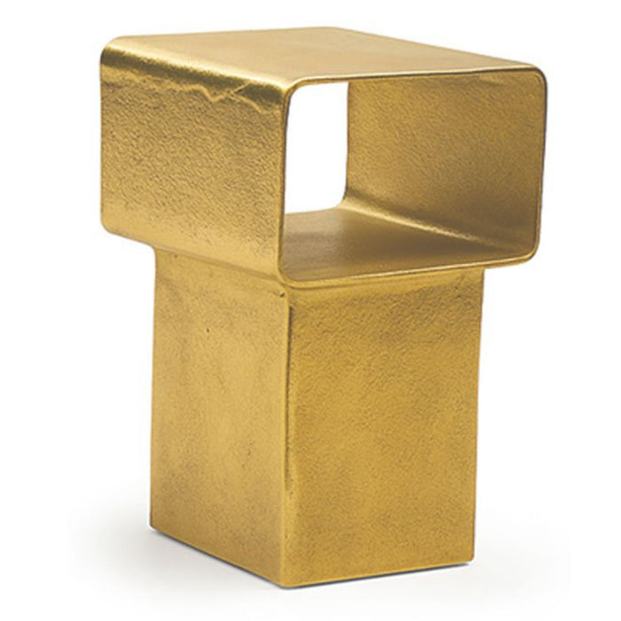 The Gervasoni Kira Side Table is a modern, gold-toned cast aluminum piece with a matte textured finish and an open rectangular frame on a solid base, inspired by modern sculpture.