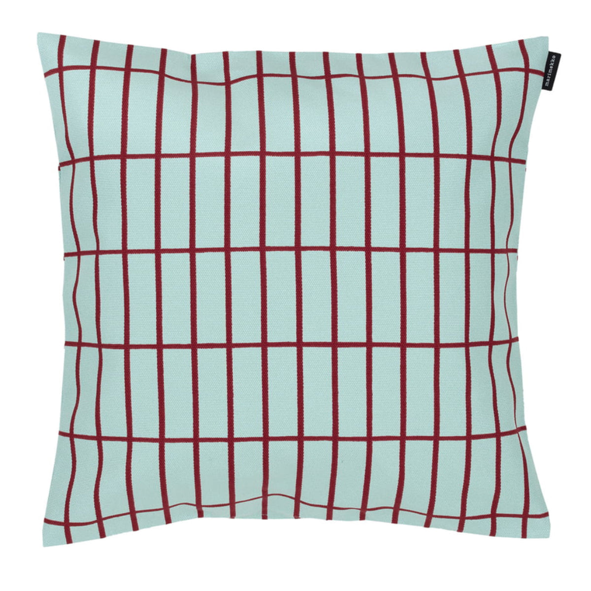 The Marimekko Pieni Tiiliskivi Cushion in Aqua (40cm) features a square shape with a light blue background, thin red grid lines, and a small black fabric tag on the top right edge, inspired by Marimekko’s iconic design.