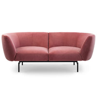 The Saba Rendez-Vous 2-Seater Sofa features modern pink upholstery, curved armrests and backrest, and a minimalist black metal base and legs, shown against a plain white background.