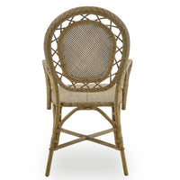 The Romantica Wicker Chair by Sika Design is a handmade rattan dining chair with armrests and a rounded, intricately woven backrest, shown from the back against a white background.