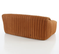 The Sandra Small Sofa, Vidar by Ligne Roset is a modern, armless retro classic with soft tan-brown upholstery and vertical quilting—a gently curved, plush design inspired by iconic Ligne Roset sofas.