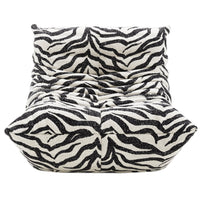 A plush, modern Togo Fireside Chair by Ligne Roset in the Tablu style, inspired by the iconic design, features black and white zebra print upholstery with deep tufts and a low, armless silhouette, shown from the front.