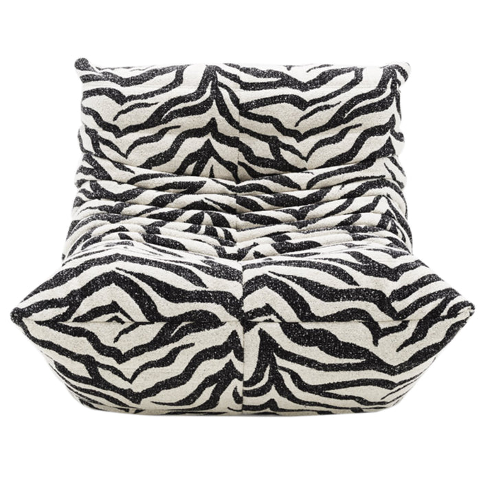 A plush, modern Togo Fireside Chair by Ligne Roset in the Tablu style, inspired by the iconic design, features black and white zebra print upholstery with deep tufts and a low, armless silhouette, shown from the front.