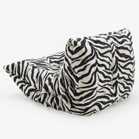 The Togo Fireside Chair, Tablu by Ligne Roset is showcased on a plain white background, featuring a low, slouchy silhouette with bold black and white zebra-print stripes and a soft, textured surface reminiscent of the iconic Togo lounge chair design.