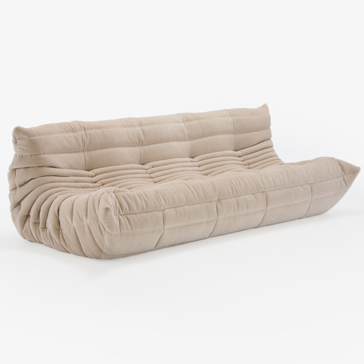 The Togo Very Large Sofa by Ligne Roset, upholstered in Phlox fabric, showcases a modern interpretation of Michel Ducaroy’s iconic design with its low, armless silhouette, pleated upholstery, and plush tufted backrest and seat, displayed against a plain white background.