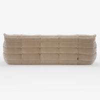 A Togo Very Large Sofa in Phlox fabric by Ligne Roset is viewed from the back, showcasing its quilted, grid-like pattern and soft, plush appearance.