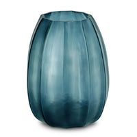 The Koonam Vase by Guaxs, in Ocean Blue/Indigo, is a tall, mouth-blown glass piece with vertical ridges, a slightly flared rim, and a translucent gradient blending dark and light blue shades.
