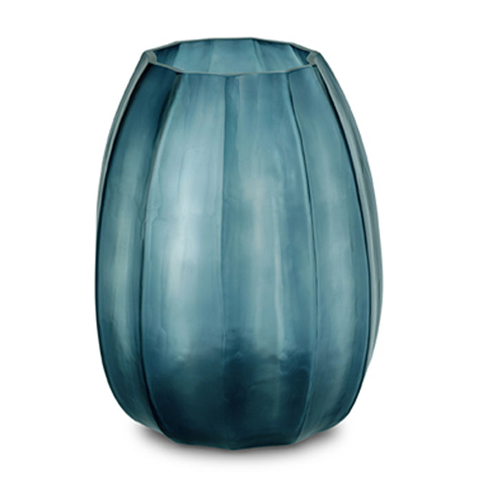 The Koonam Vase by Guaxs, in Ocean Blue/Indigo, is a tall, mouth-blown glass piece with vertical ridges, a slightly flared rim, and a translucent gradient blending dark and light blue shades.