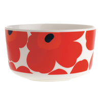 The Marimekko Oiva Unikko Bowl, Red 50cl, showcases the iconic bold red poppy flower pattern with black centers on crisp white stoneware—an everyday elegant piece crafted for lasting durability.